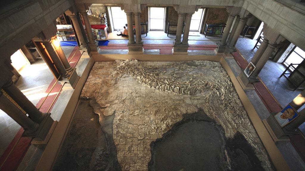 Woman in car road trip waving out the window smiling