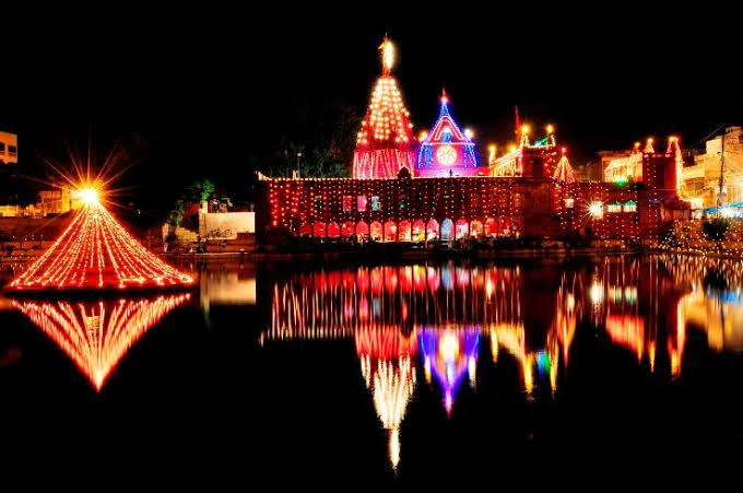 Woman in car road trip waving out the window smiling